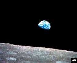 FILE - This Dec. 24, 1968, file photo made available by NASA shows the Earth behind the surface of the moon during the Apollo 8 mission.