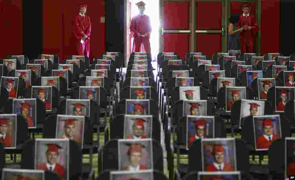 Graduating seniors of Brophy College Preparatory wait their turn to walk down the aisle to the stage individually during Diploma Days due to the coronavirus in Phoenix, Arizona, May 28, 2020.