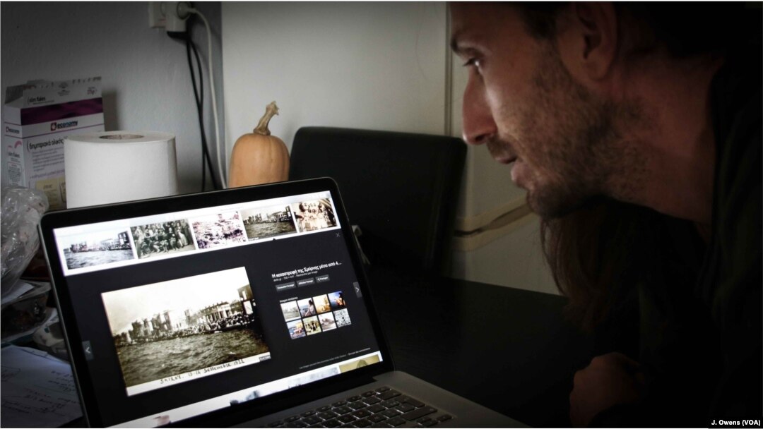 Adonis playing a video depicting the events of 1922 that led to the death of thousands of Greeks in Smyrna, now called Izmir in modern-day Turkey. His grandparents fled the city for Athens.