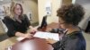 Sabine Kamagou, 19, right, gets help filling out a voter registration form from Cyndi Morrison, a worker in the Sacramento County registrar's office, in Sacramento, Calif., Oct. 22, 2018. 