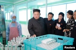 FILE PHOTO: North Korean leader Kim Jong Un and wife Ri Sol Ju visit a cosmetics factory in this undated photo released by North Korea's Korean Central News Agency (KCNA) in Pyongyang on October 28, 2017.