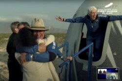 Billionaire businessman Jeff Bezos and pioneering female aviator Wally Funk emerge from their capsule after their flight aboard Blue Origin's New Shepard rocket on the world's first unpiloted suborbital flight near Van Horn, Texas, U.S., July 20, 2021 in