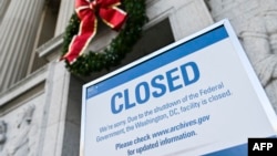 A sign is seen at the National Archives building that is closed because of a partial U.S. government shutdown in Washington, Dec. 22, 2018.