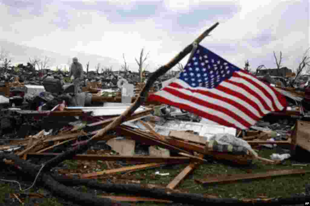Josh Ramsey looks through the rubble of what is left of his mother-in-law's home following a tornado Monday, May 23, 2011, in Joplin , Mo. A massive tornado that tore a six-mile path across southwestern Missouri killed at least 89 people as it smashed th