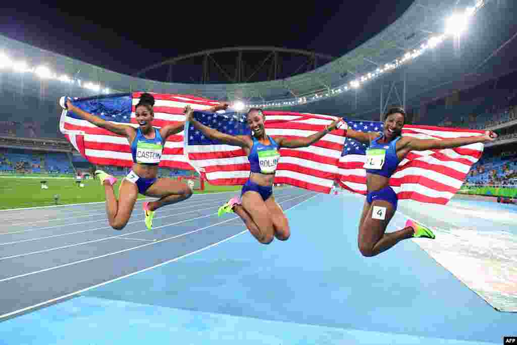 (L-R) Bronze medalist USA's Kristi Castlin, gold medalist USA's Brianna Rollins and silver medalist USA's Nia Ali celebrate after the Women's 100m Hurdles Final during the athletics event at the Rio 2016 Olympic Games at the Olympic Stadium in Rio de Janeiro, Brazil, Aug. 17, 2016.