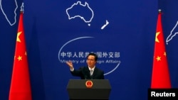FILE - China's Foreign Ministry spokesman Hong Lei conducts a news conference in Beijing.