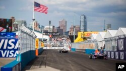 Sam Bird, right, drives during the Formula E all-electric New City ePrix, July 15, 2017, in the Brooklyn borough of New York. 