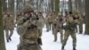 Members of Ukraine's Territorial Defense Forces, volunteer military units of the Armed Forces, train in a city park in Kyiv, Ukraine, Jan. 22, 2022.