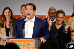 Bruce Harrell, who ran against Lorena Gonzalez in the race for mayor of Seattle, speaks to supporters as his wife, Joanne Harrell, right, applauds, in Seattle, Nov. 2, 2021.