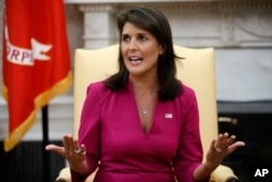 FILE - Outgoing U.S. Ambassador to the United Nations Nikki Haley speaks during a meeting with President Donald Trump in the Oval Office of the White House, Oct. 9, 2018.