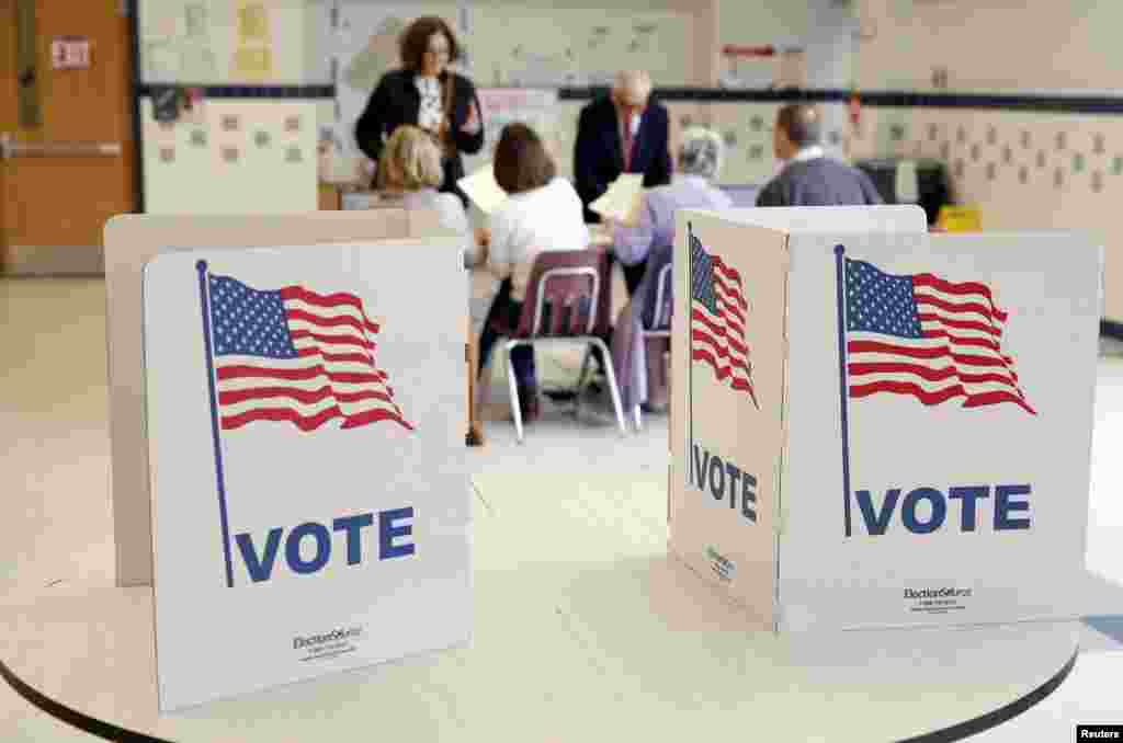 Voters receive their ballot to vote in the Super Tuesday election at Sleepy Hollow Elementary School in Falls Church, Virginia, March 1, 2016.