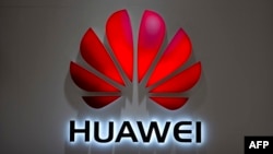 FILE - In this July 4, 2018, photo, the Huawei logo is seen at a Huawei store at a shopping mall in Beijing. 