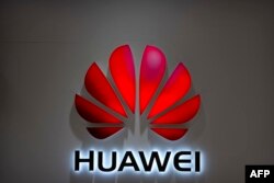 FILE - The Huawei logo is seen in a Beijing mall, July 4, 2018.