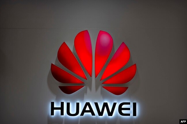 FILE - The Huawei logo is seen in a Beijing mall, July 4, 2018.