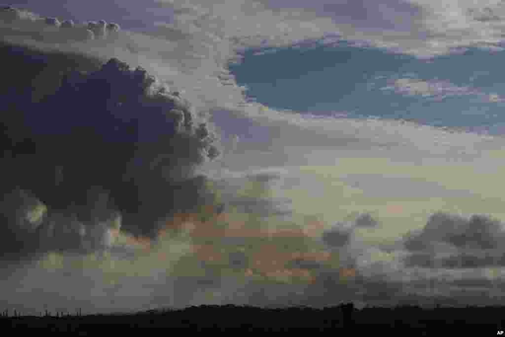 Smoke and volcanic gases rise from the Leilani Estates, Sunday, May 6, 2018, near Pahoa, Hawaii. Scientists reported lava spewing more than 200 feet (61 meters) into the air in Hawaii's recent Kilauea volcanic eruption.