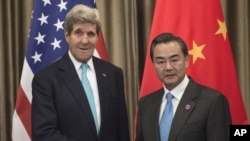 U.S. Secretary of State John Kerry, left, and Chinese Foreign Minister Wang Yi meet on the sidelines of the Asia-Pacific Economic Cooperation (APEC) meeting in Beijing Friday, Nov. 7, 2014.