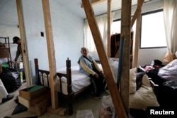Carmen Machargo Tellez, 94, is pictured inside her apartment in the Tlalpan neigborhood, where her building was damaged by the devastating earthquake, that took place in Mexico City last year, Mexico, August 31, 2018.