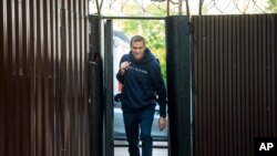 Russian opposition leader Alexei Navalny leaves a detention center after his release, in Moscow, Russia, Friday, Aug. 23, 2019.