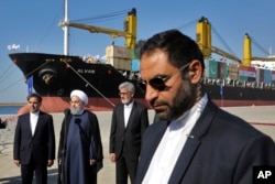 FILE - Iranian President Hassan Rouhani, second left, speaks during the inauguration a newly built extension of the port of Chabahar, near the Pakistani border, on the Gulf of Oman, southeastern Iran, Dec. 3, 2017.