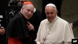 Pope Francis, right, shakes hands with Cardinal Carlos Aguiar Retes, at the Vatican, Nov. 23, 2016. On Thursday, Francis appointed Aguiar archbishop of Mexico City.