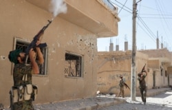 Para kombatan dari Unit Perlindungan Rakyat menembak drone yang dioperasikan militan ISIS di Raqqa, Suriah, 16 Juni 2017. (Foto: Reuters/Goran Tomasevic)