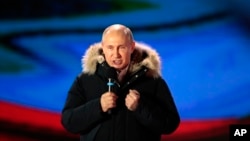 Russian President Vladimir Putin speaks during a rally near the Kremlin in Moscow, Sunday, March 18, 2018. 