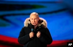 Russian President Vladimir Putin speaks during a rally near the Kremlin in Moscow, Sunday, March 18, 2018.