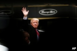 Republican presidential candidate Donald Trump acknowledges supporters while leaving Trump Tower on his way to visit the World Trade Center Museum, in New York, April 9, 2016.