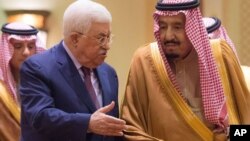 FILE - In this photo released by Al-Ekhbariya, Saudi King Salman, right, receives Palestinian President Mahmoud Abbas after he arrives in Riyadh, Saudi Arabia, Dec. 20, 2017. 