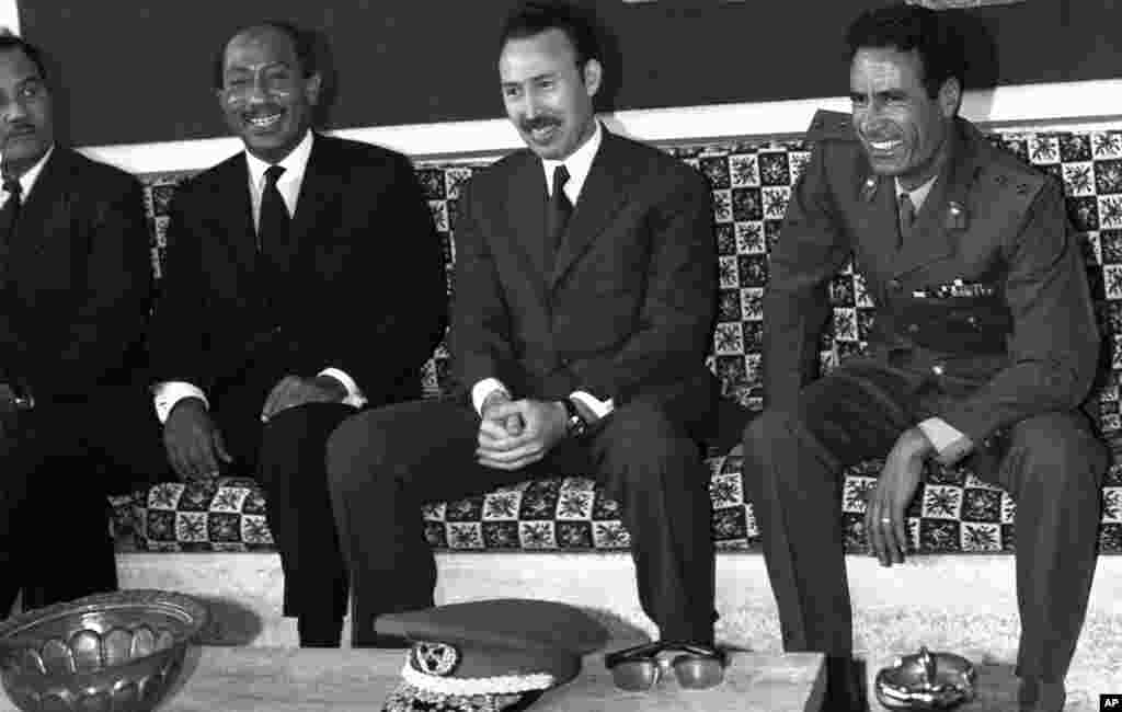 File picture (1972) of Libyan leader Col. Moammar Gadhafi (R) with Egyptian President Anouar al-Sadate (L) and Algerian President Houari Boumediene (C) at the airport while they arrived, (AFP)