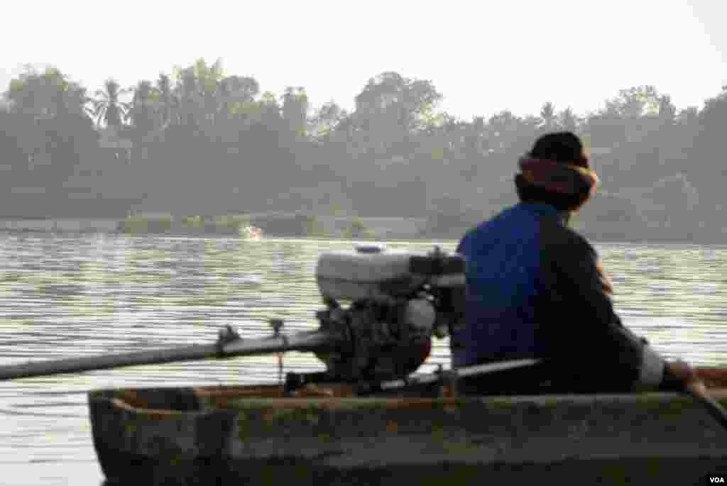 Irrawaddy dolphin spotting has become a treat for tourists. The break in the water in this photo is a dolphin. Environmentalists fear for the dolphins future, warning that damage to fish stocks and water fluctuation caused by the dam could further harm th