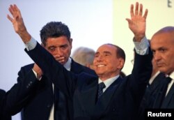 Forza Italia party leader Silvio Berlusconi waves as he leaves at the end of a rally in Catania, Italy, Nov. 2, 2017.