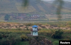 FILE - North Korean soldiers stand guard at a sentry on the Yalu River near the North Korean city of Hyesan, Ryanggang province, opposite the Chinese border city of Linjiang.