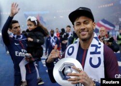 L'attaquant brésilien Neymar tient son trophée après avoir remporté le titre de champion de France L1 à la fin du match de football L1 français PSG vs Rennes, le 12 mai 2018.