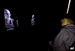A visitor views a multimedia exhibition that marks the 100th anniversary of the creation of Czechoslovakia, in Prague, Czech Republic, Oct. 3, 2018.