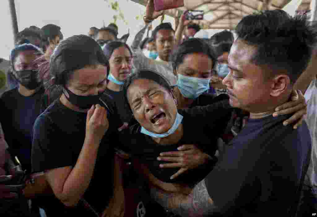 Thida Hnin cries during the funeral of her husband Thet Naing Win at Kyarnikan cemetery in Mandalay, Myanmar. He was shot and killed by security forces during an anti-coup protest on Feb. 20.