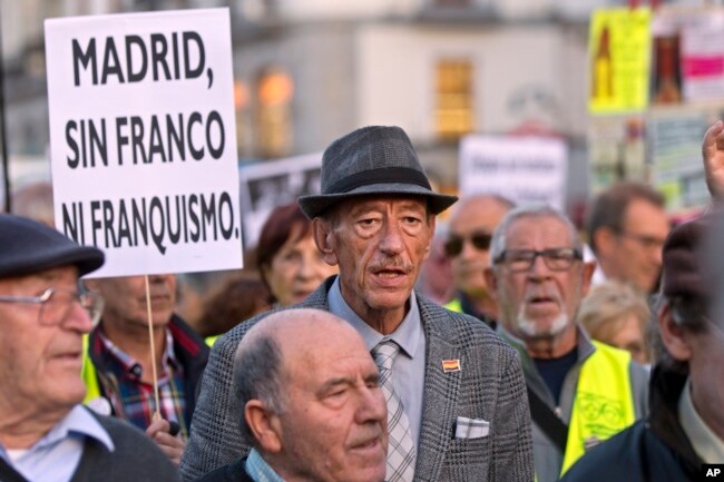 FILE - Protesters march in Madrid, Spain, Oct. 25, 2018. Hundreds of demonstrators are urging the government and Catholic church authorities to prevent the remains of the country’s 20th century dictator from ending in the city’s cathedral.