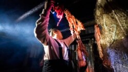 Kori Williams, 17, hangs moose intestines in the smokehouse of the Stevens family hunting camp, Sept. 15, 2021, near Stevens Village, Alaska.