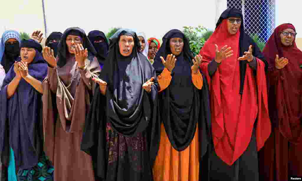 Somali women whose sons are missing after they were taken for military training pray after talking with Reuters reporters, in Mogadishu, Somalia.