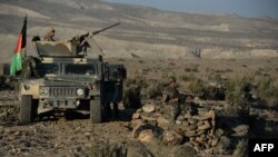 FILE - Afghan security forces take positions following an operation against Islamic State militants in Pachiragam district of Nangarhar province, Dec. 3, 2016. 