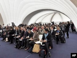 Visitors listen inside the U.S. Climate Action Center at the COP 23 Fiji U.N. Climate Change Conference in Bonn, Germany, Nov. 9, 2017.