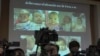 FILE - The media attend a press briefing where Thai police display projected pictures of surrogate babies born to a Japanese man who is at the center of a surrogacy scandal during a press conference at the police headquarters in Chonburi, Thailand, Aug. 12, 2014.