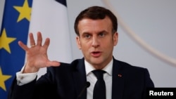 French President Emmanuel Macron gestures as he delivers a speech after a meeting via video-conference with leaders of West African G5 Sahel nations, in Paris, France February 16, 2021.