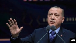 FILE - Turkey's President Recep Tayyip Erdogan speaks in Ankara, March 19, 2018. Erdogan has said that candidates deemed sympathetic to the PKK who win in the March 2019 local elections will be removed.