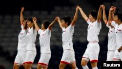 FILE - North Korea's players celebrate after winning their women's Group G football match against Colombia at the London 2012 Olympic Games in Glasgow, Scotland Jul. 25, 2012.