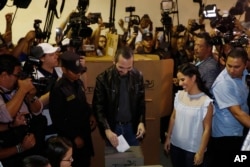Presidential hopeful Nayib Bukele casts his ballot as he and his wife Gabriela vote in the presidential election in San Salvador, El Salvador, Feb. 3, 2019.