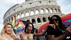 People march past the Colosseum during a gay-pride parade in Rome, June 11, 2016.