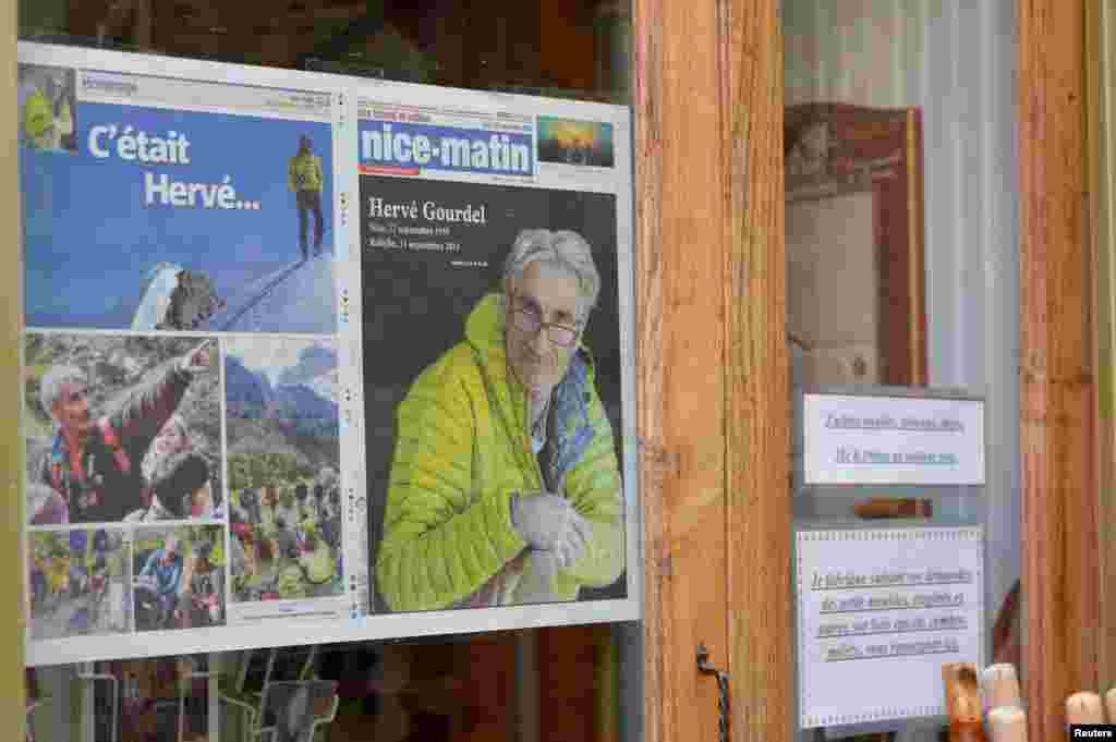 The front page of French newspaper Nice Matin, with a portrait of mountain guide Frenchman Herve Gourdel, is displayed on a shop window in Saint-Martin-Vesubie, Sept. 25, 2014. 