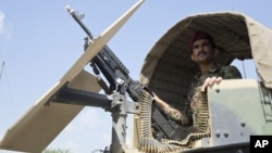 FILE - An Afghan National Army soldier stands guard in Camp Khogyani in Nangarhar province, east of Kabul, a region where homegrown militants loyal to the Islamic State group have made some inroads, Aug. 5, 2015.