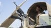 FILE - An Afghan National Army soldier stands guard in his vehicle in Camp Khogyani in Nangarhar province, east of Kabul — a region where homegrown militants loyal to the Islamic State group have made some inroads, Aug. 5, 2015.